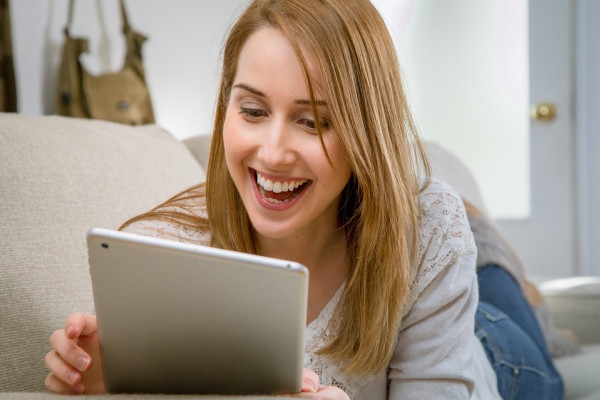 this is a picture of a woman using a tablet computer