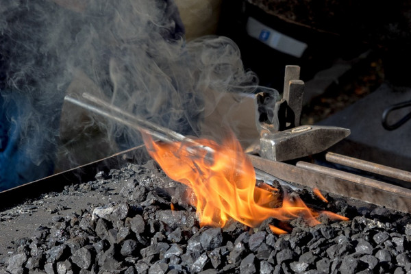 Sword sitting in a forge's embers 