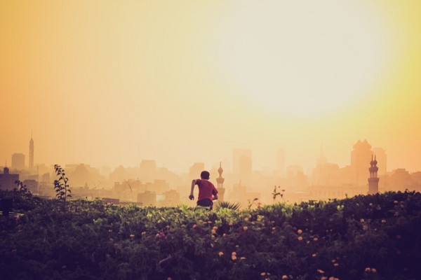 a child running away from the camera into the sunset