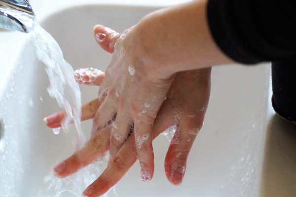 A person washing their hands.