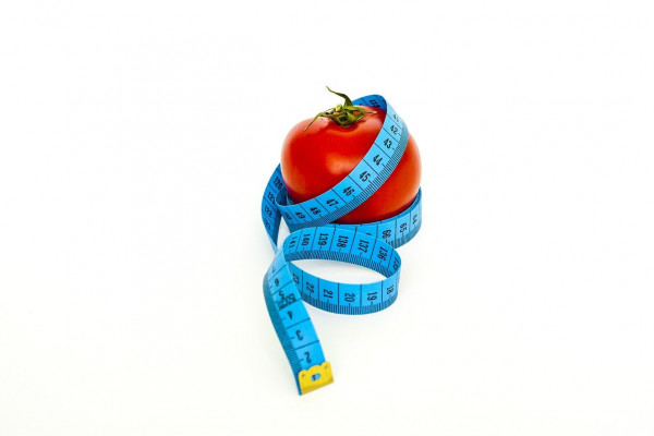 measuring tape around a tomato