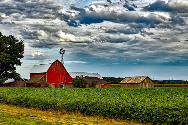 A red barn in a farmer's field