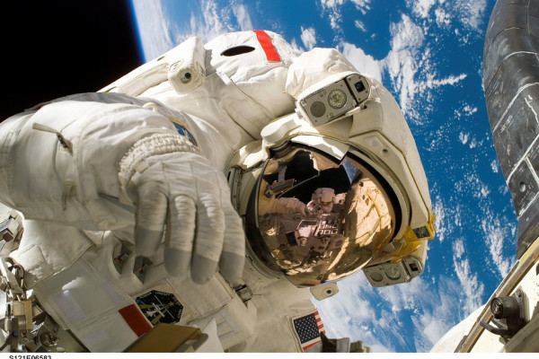 Astronaut spacewalking above Earth