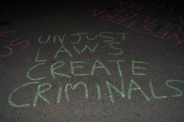 Unjust laws create criminals graffiti