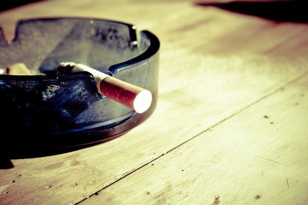 Cigarette in ash tray. 