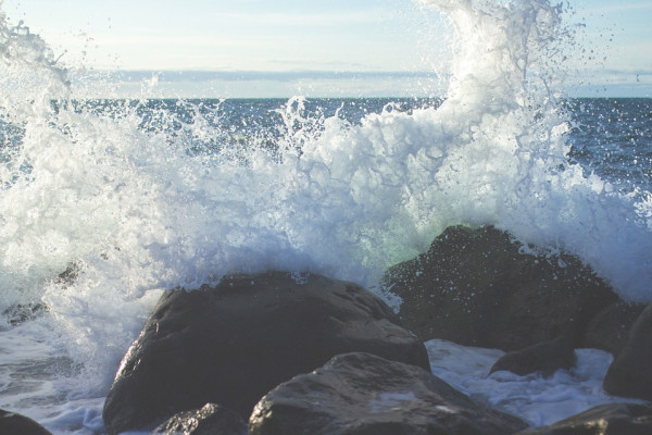 This is a picture of waves splashing against rocks.