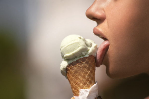 A woman licking ice cream