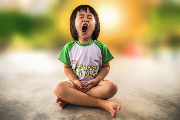 girl yawning whilst seated