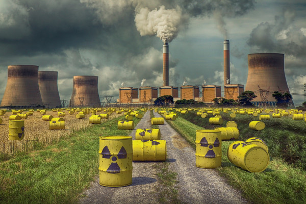 Yellow barrels of nuclear waste photoshopped in front of a nuclear power plant