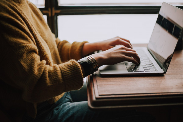 A person sitting on a laptop working