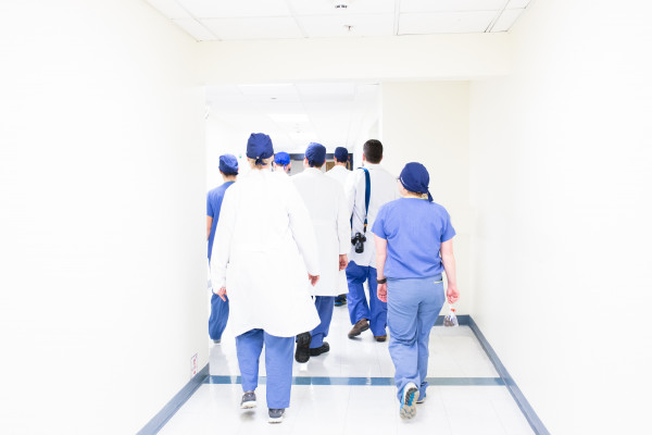 A team of doctors walking through a hospital corridor