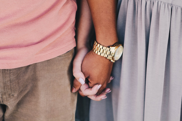 A man and woman holding hands