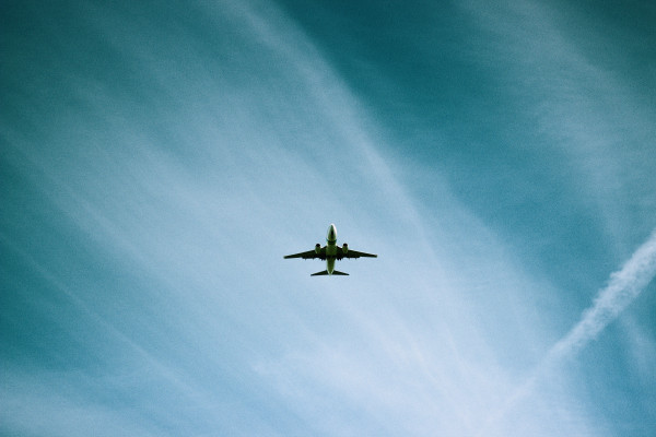 Plane flying through light clouds