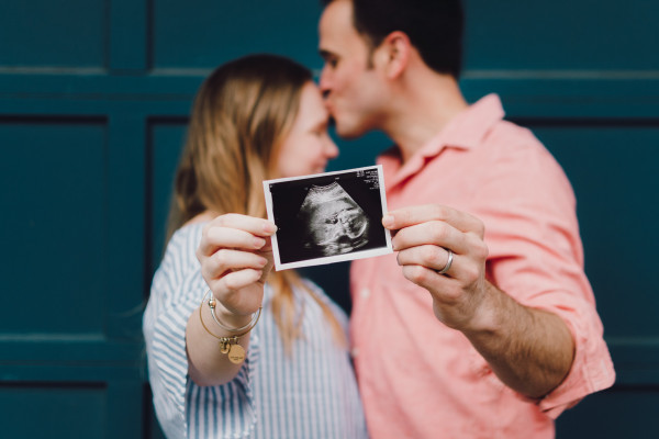 Couple holding ultrasound baby scan
