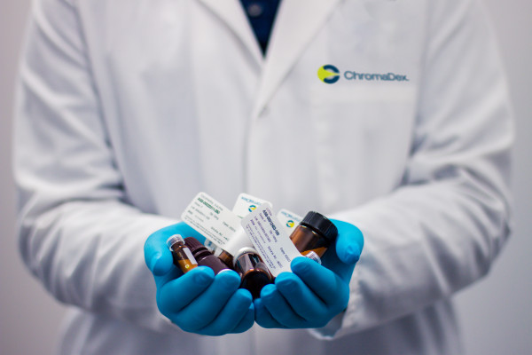 Drug bottles held in a doctor's hand