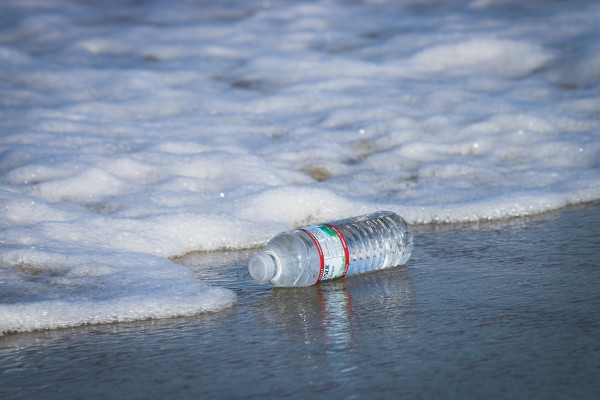 A discarded plastic bottle on the seashore