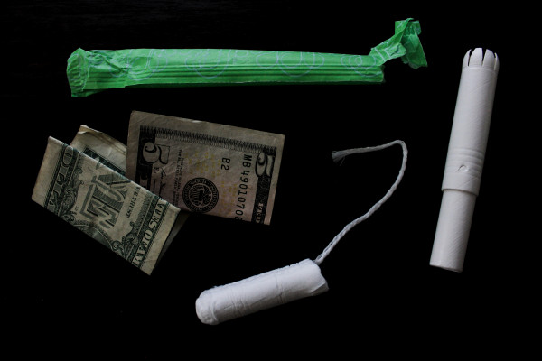 photograph of a tampon and some dollars