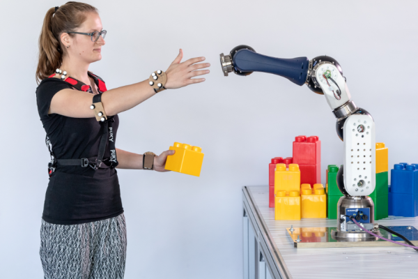 Human interacting with robot arm