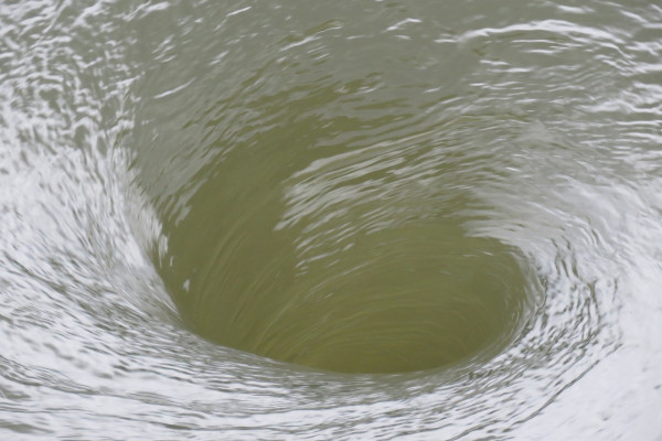 Water swirling into a vortex.