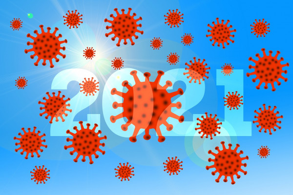 Coronavirus particles over "2021".