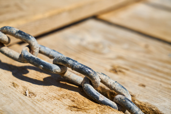A chain running across a wooden deck.