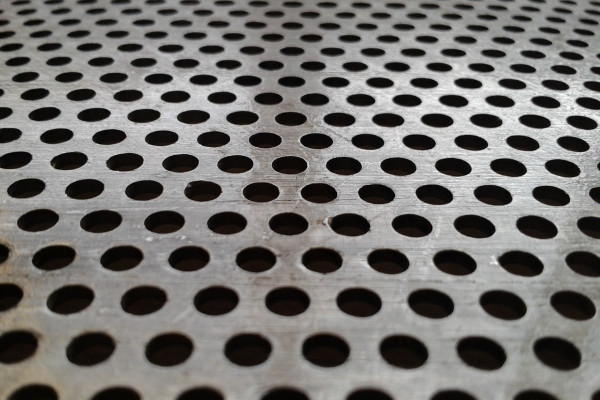 Steel sheet with drilled holes in regular pattern