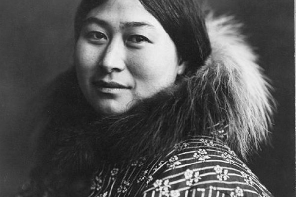 Photograph of an Alaska Native woman wearing a coat with a fur collar.