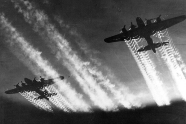Two B-17 Flying Fortresses' vapor trails light up the night sky over Eastern Europe