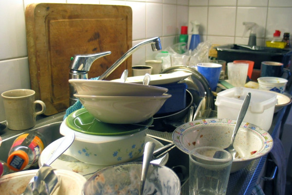 Unwashed dishes in a sink; an authentic situation.