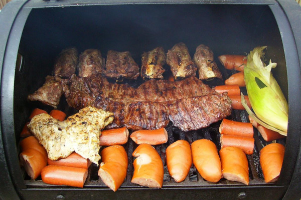 A typical Laredo, Texas BBQ grill - Fajita center, Chicken left, Ribs above, Sausage bottom, Corn right.