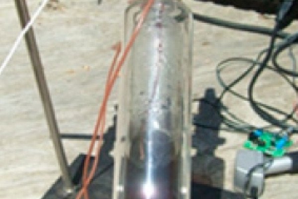  Photograph of system used in the temperature evolution of solar steam generation: (a) transparent vessel isolated with a vacuum jacket to reduce thermal losses, (b) two thermocouples for sensing the solution and the steam temperature, (c) pressure...