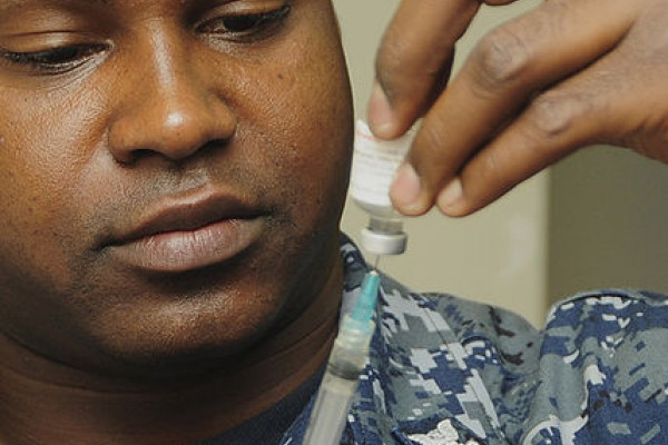 Healthcare worker drawing up influenza (flu) vaccine shot