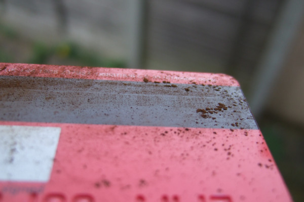 Fine particles of rust show up the magnetic lines on a credit card