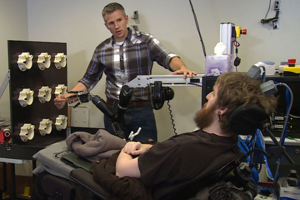 Dr Robert Gaunt, from the University of Pittsburgh, with Nathan Copeland, who sustained a spinal injury ten years ago and now has received a brain implant enabling him to experience \sensations\ with this hand.