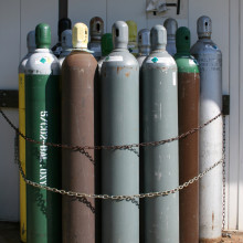 An assortment of compressed gas tanks chained to a wall at Duke University in Durham, North Carolina