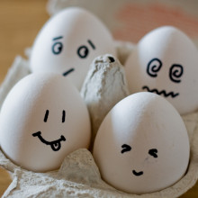 Eggs in an egg box, with faces