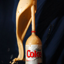 A Coke bottle erupting when Mentos are added