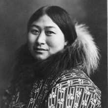 Photograph of an Alaska Native woman wearing a coat with a fur collar.