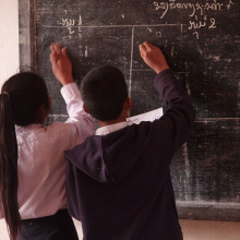 Schoolchildren writing on a blackboard