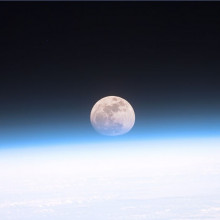 The moon partially obscured by the atmosphere