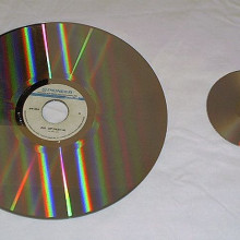 A laserdisc (left) compared with a DVD (right).