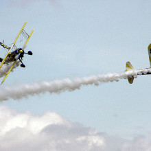 The UK Utterly Butterly display team perform an aerobatic manoeuvre with their Boeing Stearmans, at an air display in England.