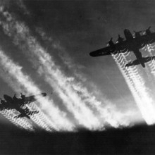 Two B-17 Flying Fortresses' vapor trails light up the night sky over Eastern Europe