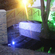 Bella's Bridge over the Whitelake River, on the site of the Glastonbury Festival. Illuminated with coloured lights