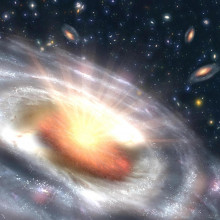 A growing black hole, called a quasar, can be seen at the center of a faraway galaxy in this artist's concept.