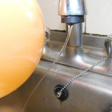 The charged balloon bends the stream of water
