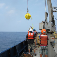 DOV Karen brought onboard - glass buoyancy and communication sphere seen in yellow housing.