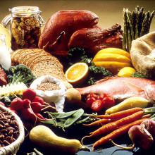  This image shows a display of healthy foods on a table. Foods include beans, grains, cauliflour, cantelope, pasta, bread, orange, turkey, salmon, carrots, turnips, zucchini, snowpeas, string beans, radishes, asparagus, summer squash, lean beef,...