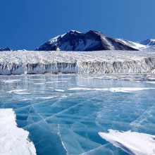 Antarctica: The blue ice covering Lake Fryxell, in the Transantarctic Mountains, comes from glacial meltwater from the Canada Glacier and other smaller glaciers. The freshwater stays on top of the lake and freezes, sealing in briny water below.