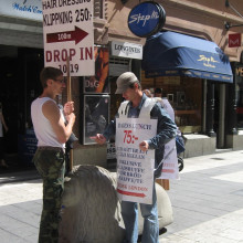 Two human billboards in Drottninggatan, Stockholm.